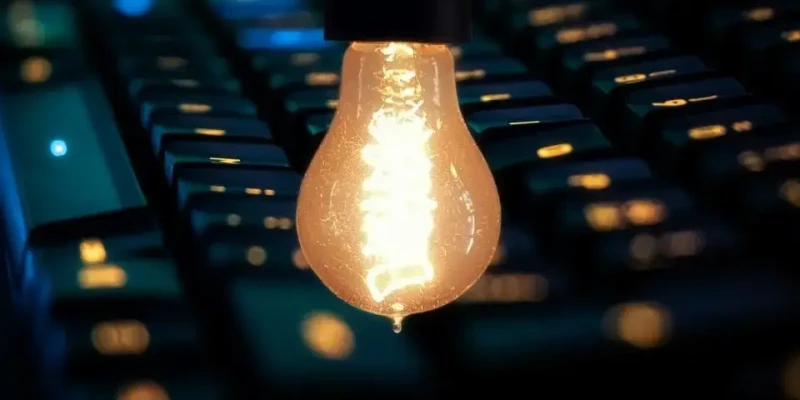 Une ampoule éclairée au-dessus un clavier d'ordinateur
